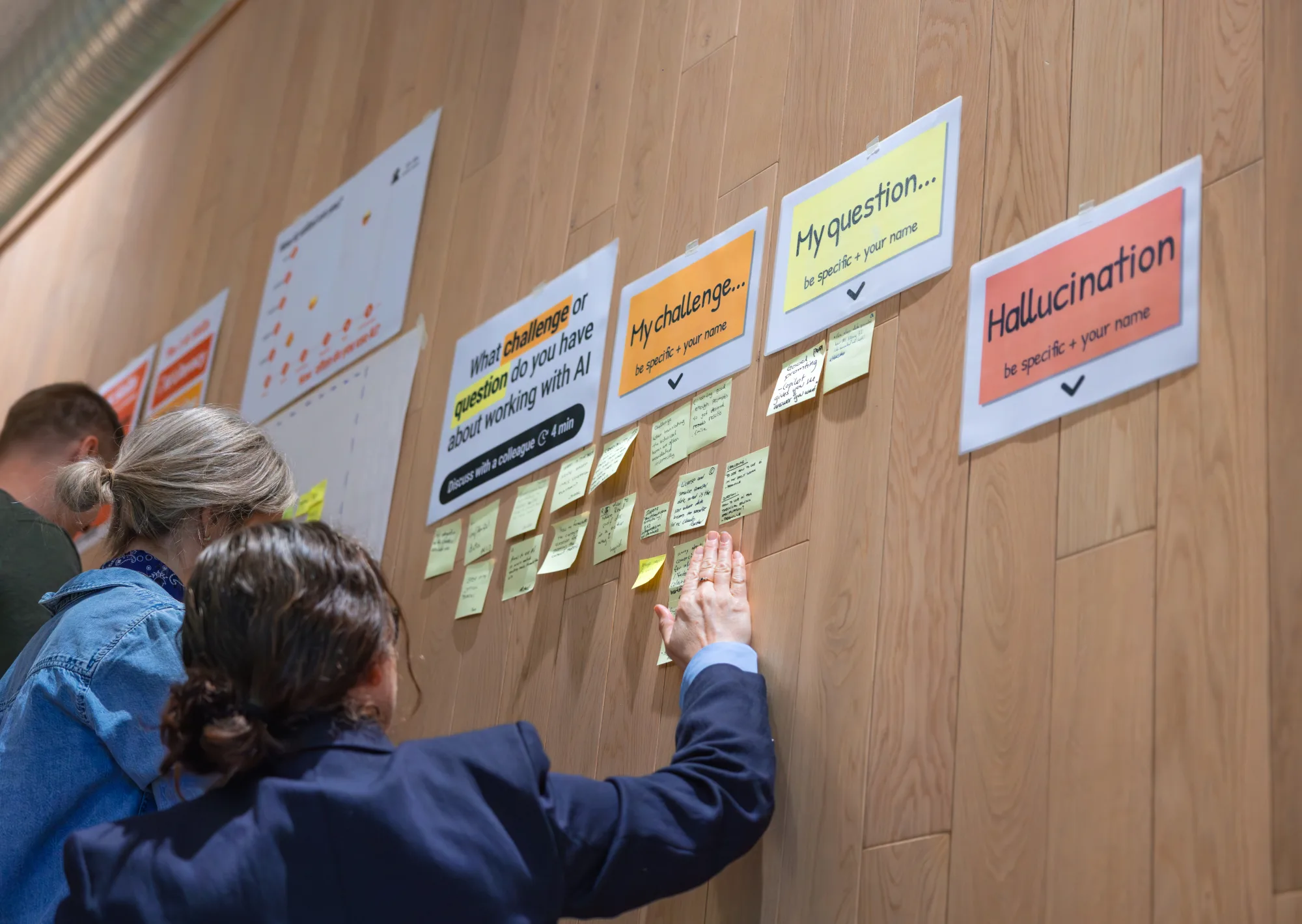 Participants reading the output of a group exercise on the wall together