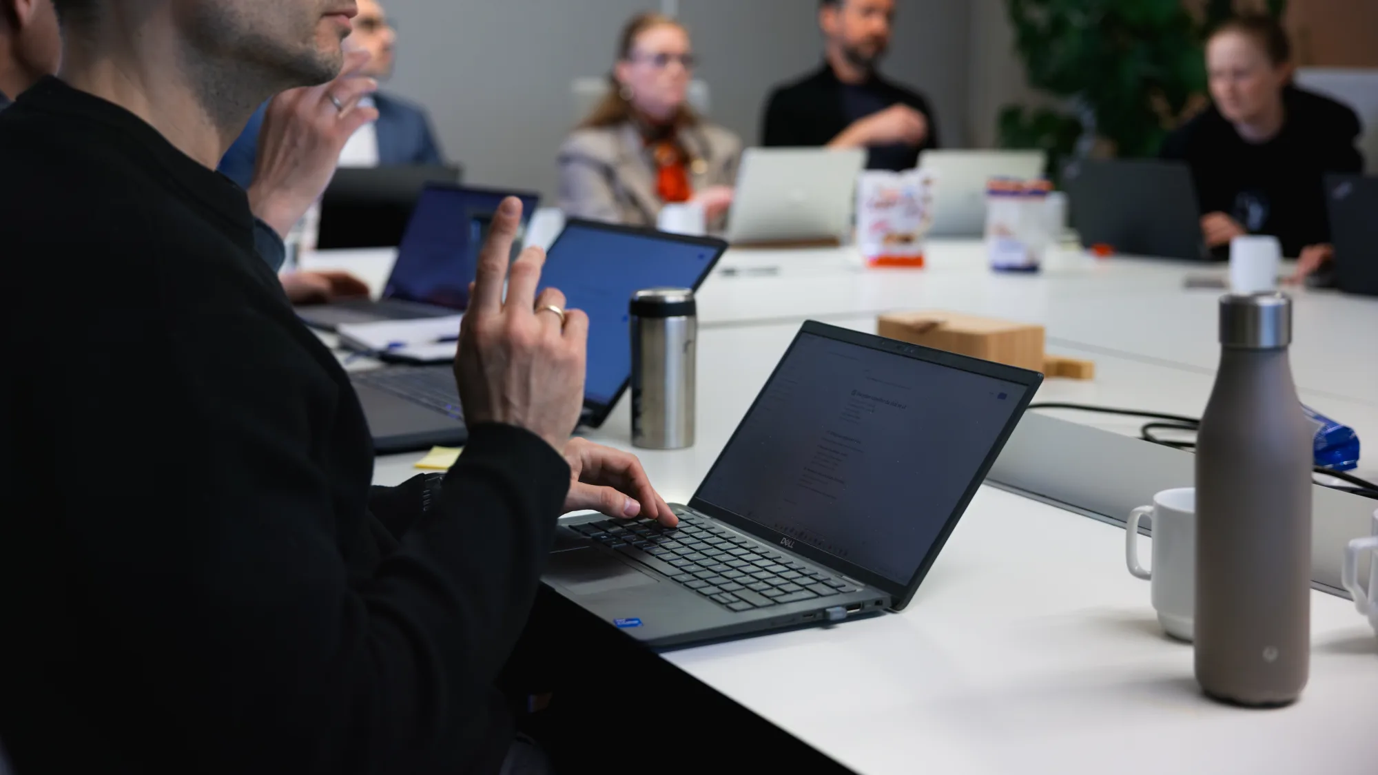 Hands typing on a laptop during the build-test loop of the knowledge base
